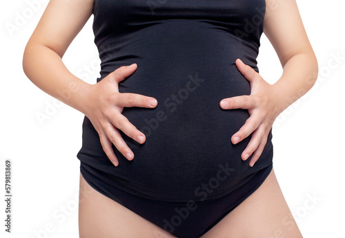 Young pregnant woman in black shirt posing.