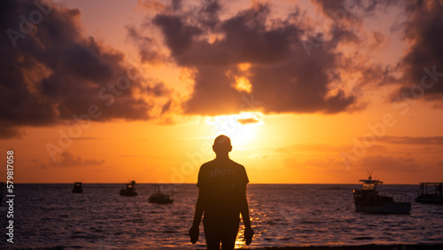 Silhouette of man at dawn on the beach