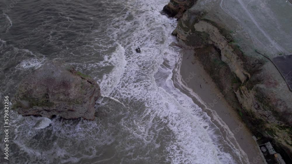 Drone flies directly over Marsden Rock in North East England on a very stormy winter day Drone flies directly over Marsden Rock in North East England on a very stormy winter day