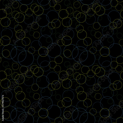 Seamless pattern with blue and yellow circles and dots of different sizes in a chaotic manner. Various diameter round shapes randomly placed on black background. Vector texture for textile print.