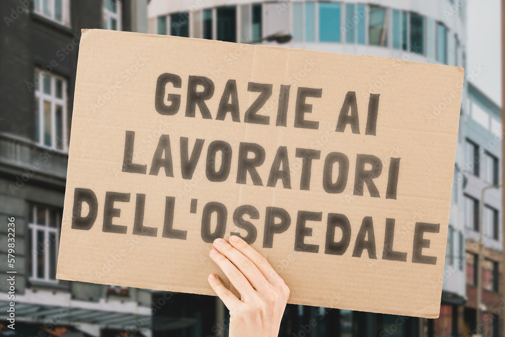 The phrase " Thank you hospital workers " on a banner in hand. The