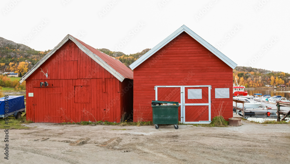 Red wooden barns stand at the sea coast. Norway Red wooden barns stand at the sea coast. Norway