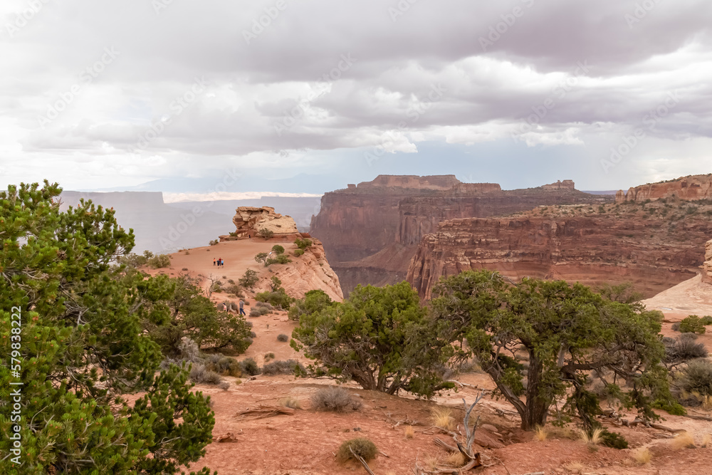 Panoramic aerial view on Colorado River canyon seen from Saffer Canyon Overlook near Moab, Island in the Sky District, Canyonlands National Park, San Juan County, Utah, USA. Clouds and sky in summer