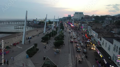  pedestrian zone between amusement park and nightlife entertainment street. Slowly moving cars after sunset photo