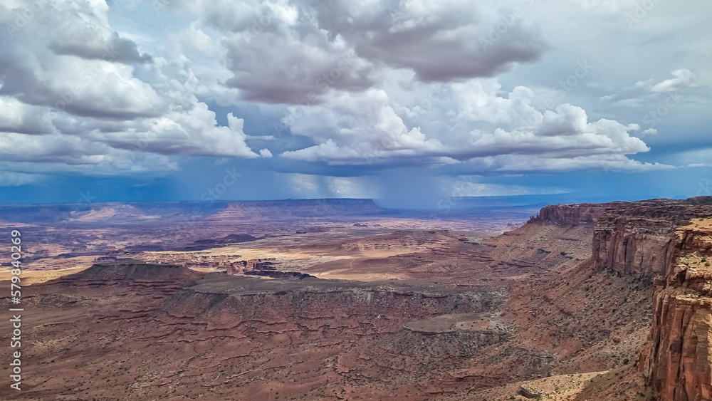 Panoramic aerial view on Colorado River canyon seen from Buck Canyon Overlook near Moab, Island in the Sky District, Canyonlands National Park, San Juan County, Utah, USA. Clouds and sky in summer