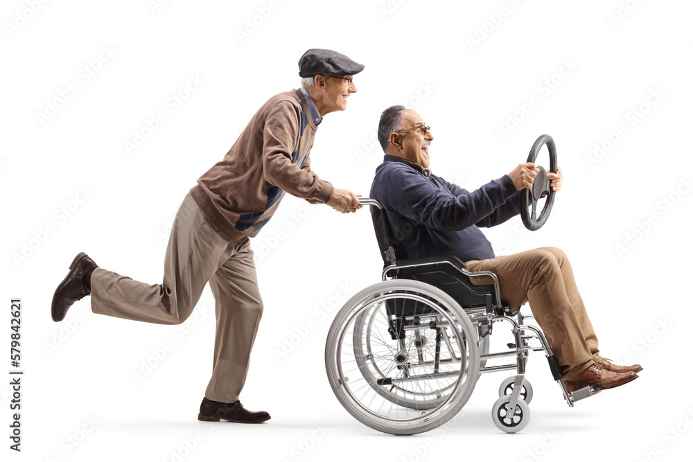 Full length profile shot of an elderly man pushing a mature man in a wheelchair holding a steering wheel Full length profile shot of an elderly man pushing a mature man in a wheelchair holding a steering wheel