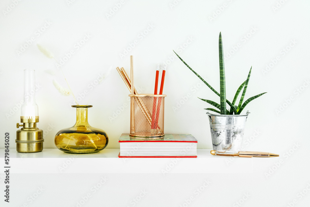 white shelf with decorative objects and indoor plants white shelf with decorative objects and indoor plants