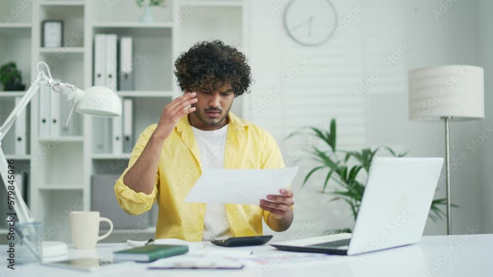 young financier entrepreneur is unhappy with a bad financial result Upset worker man manager or owner Does not understand documents dissatisfied with unexpectedly bad financial project at office young financier entrepreneur is unhappy with a bad financial result Upset worker man manager or owner Does not understand documents dissatisfied with unexpectedly bad financial project at office