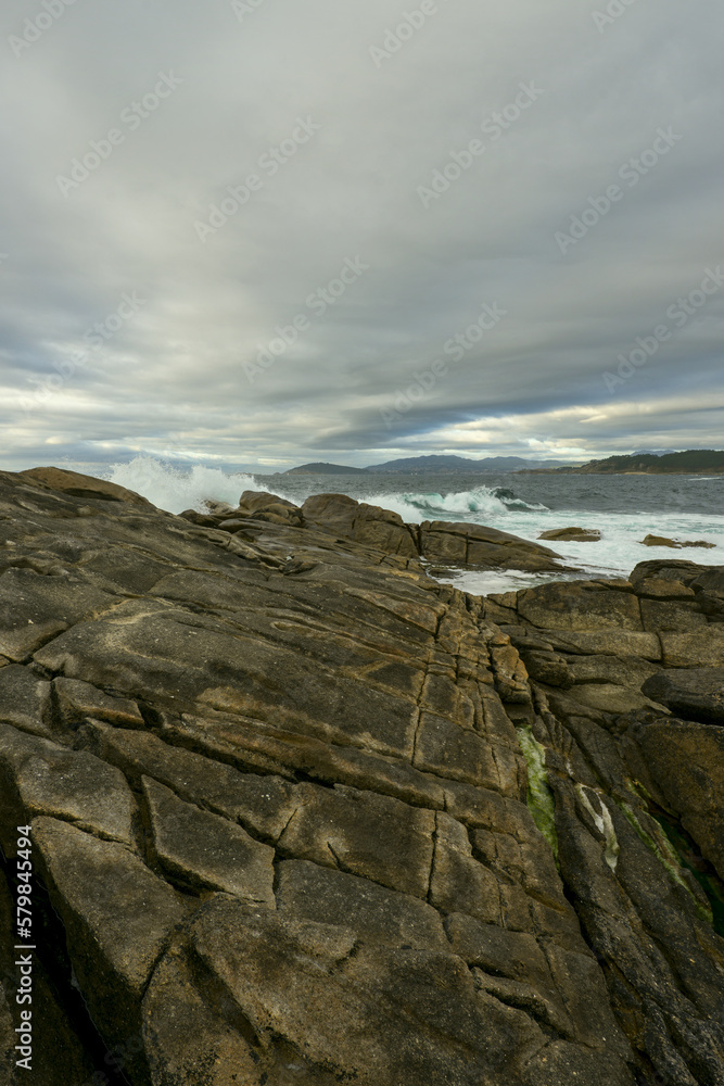 Fototapeta premium A stormy day on the coast with an agitated sea reaches the cliffs with large waves
