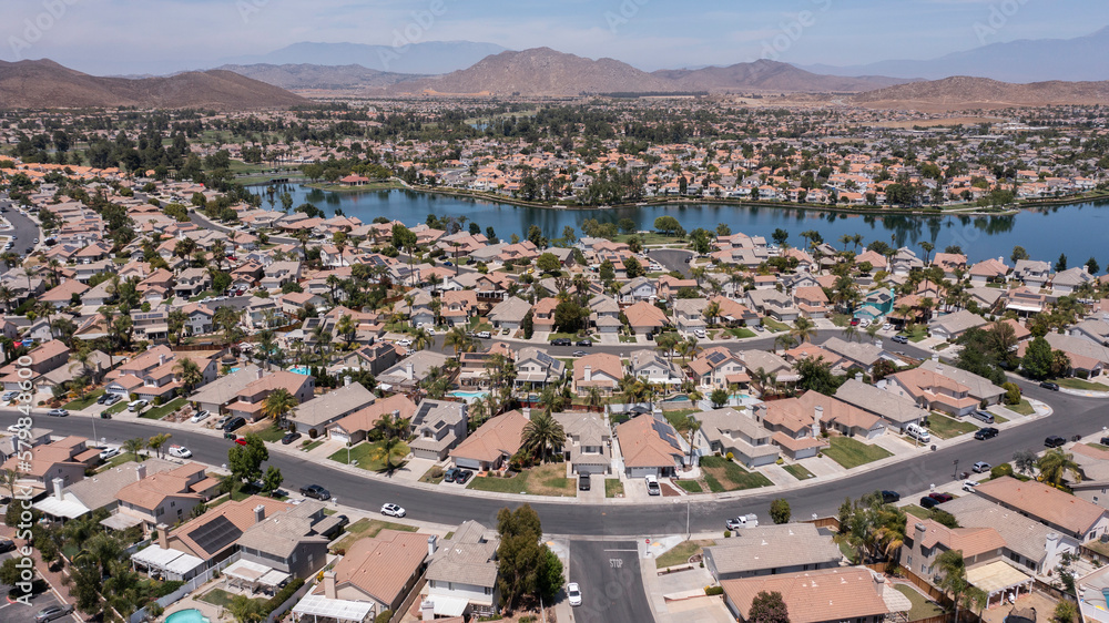 Aerial view of sprawling single family home neighborhood and lake of Menifee, California, USA.