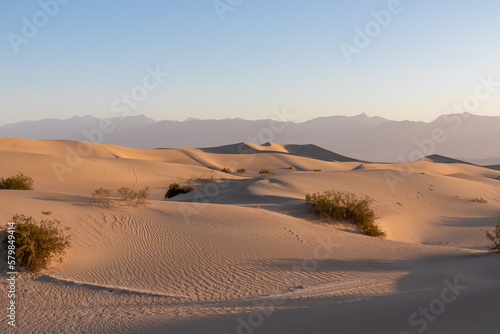 Obraz na płótnie Scenic view on natural ripple sand pattern during sunrise at Mesquite Flat Sand Dunes, Death Valley National Park, California, USA. Morning walk in Mojave desert with Amargosa Mountain Range in back w salonie