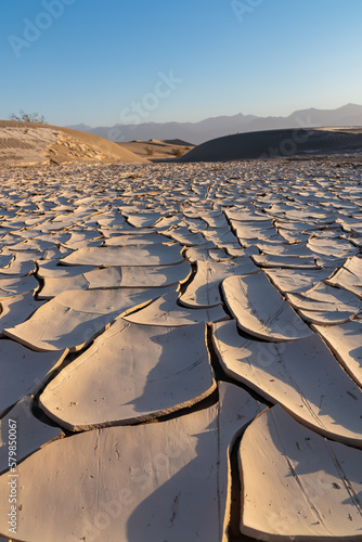 Scenic view of dry cracked clay crust at Mesquite Flat Sand Dunes in Death Valley National Park  California  USA. Looking at pattern Mojave desert in summer with Amargosa Mountain Range in the back