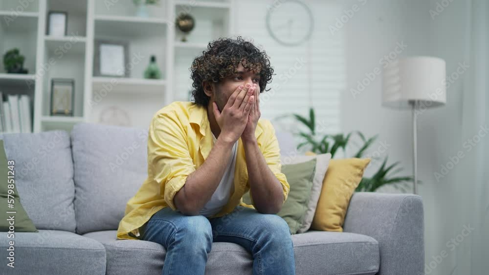 Young man suffering depression mental health problems sitting alone at home on the sofa in room Sad upset depressed unhealthy guy, young tired exhausted frustrated male having headache Failure despair Young man suffering depression mental health problems sitting alone at home on the sofa in room Sad upset depressed unhealthy guy, young tired exhausted frustrated male having headache Failure despair