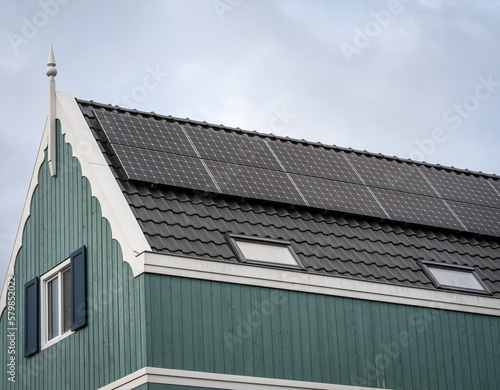 Facade of modern dutch house with solar panels, photovoltaic system installed on the roof