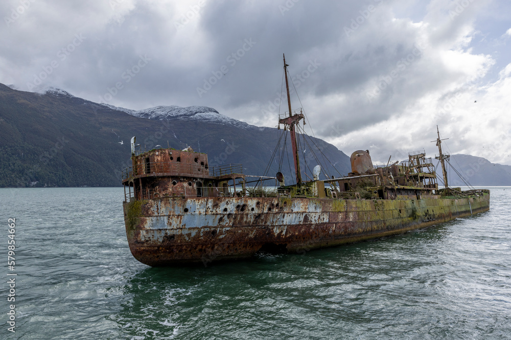 Wreck of MV Captain Leonidas, a freighter that ran aground on the Bajo Cotopaxi (Cotopaxi Bank) in 1968 – viewed from a ferry passing the Messier Channel in Patagonia, Chile Wreck of MV Captain Leonidas, a freighter that ran aground on the Bajo Cotopaxi (Cotopaxi Bank) in 1968 – viewed from a ferry passing the Messier Channel in Patagonia, Chile