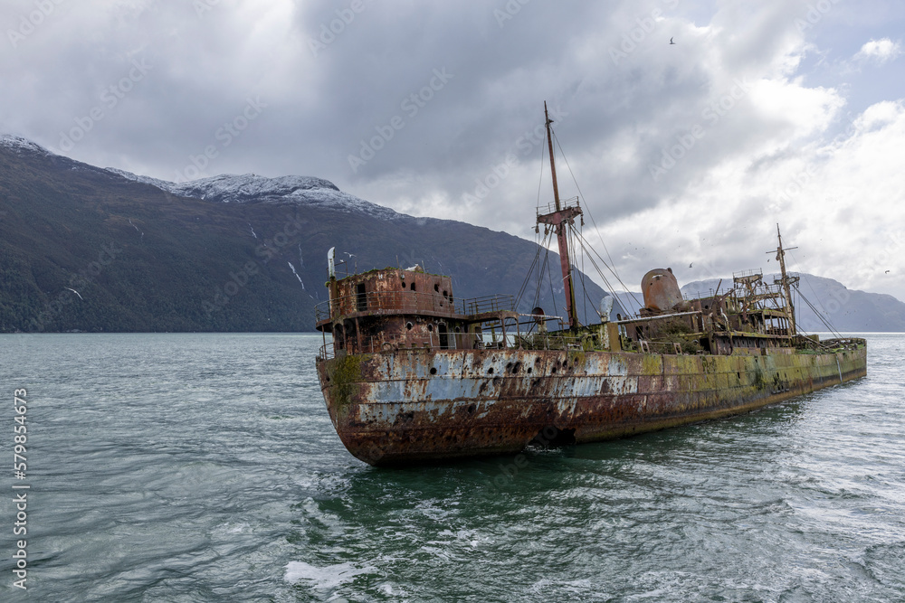 Wreck of MV Captain Leonidas, a freighter that ran aground on the Bajo Cotopaxi (Cotopaxi Bank) in 1968 – viewed from a ferry passing the Messier Channel in Patagonia, Chile 