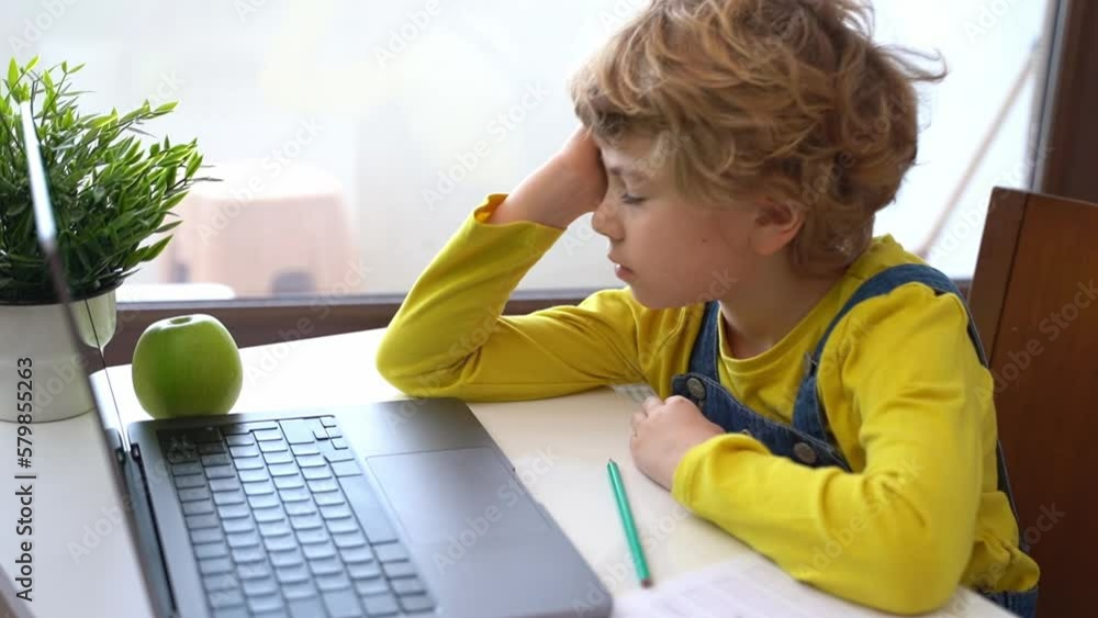 Bored Schoolboy child using laptop online educational lesson course at home. Distance learning course remote video conference. Schoolgirl study does school homework. Bored Schoolboy child using laptop online educational lesson course at home. Distance learning course remote video conference. Schoolgirl study does school homework.