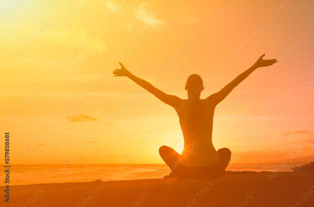 woman enjoying the beautiful sunrise feeling joyful with open arms	