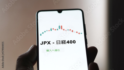 Investor analyzing an ETF. Funds stocks exchange ETFs Japanese text: jpx - Nikkei 400, buy. JPX - 日経400 証券取引所 投資 shares photo