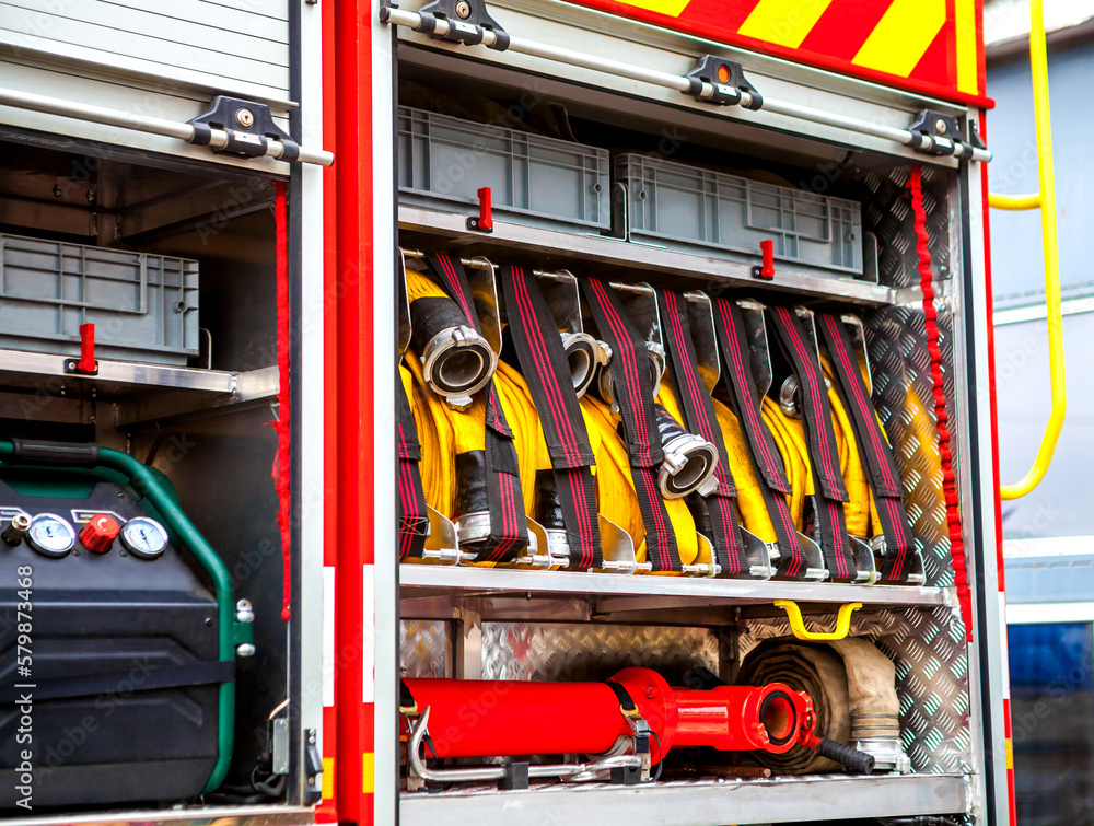 Compartment of rolled up fire hoses on a fire engine. Rescue fire truck