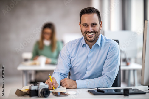 Portrait of businessman while using computer in office