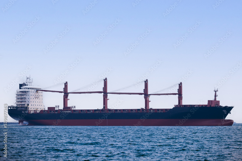 large carrier ship floating  afternoon in sea, tugboat dragging container ship, blue sky evening background and sea front, mode of transportation concept,