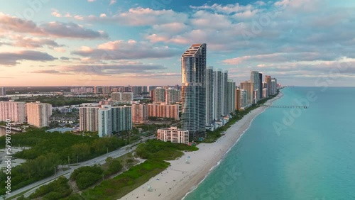 High angle view of Sunny Isles Beach city at sunset with expensive highrise hotels and condo buildings over beachfront on Atlantic shore. American tourism infrastructure in coastal southern Florida photo