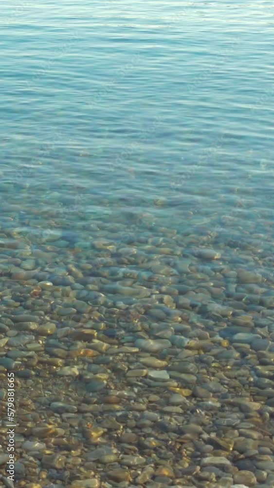 Vertical video of a pebbles stone under water surface Vertical video of a pebbles stone under water surface