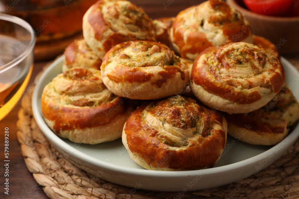 Fresh delicious puff pastry with tasty filling on wooden table, closeup