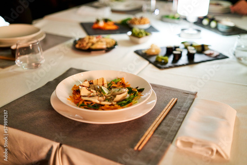 Prepared dinner in a stylish asian food restaurant. Close-up of Asian food in a dimly lit restaurant.