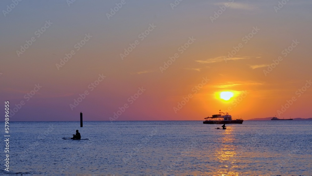 
Pattaya at Koh Larn, Chonburi province in Thailand at sunset, the sea contrasts with the orange sky, tourists rowing boats to enjoy the atmosphere