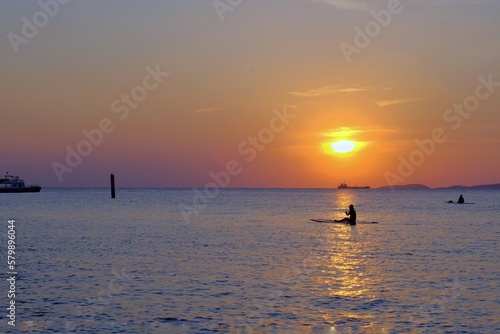 Tourists fishing on Koh Larn beach in Pattaya at sunset