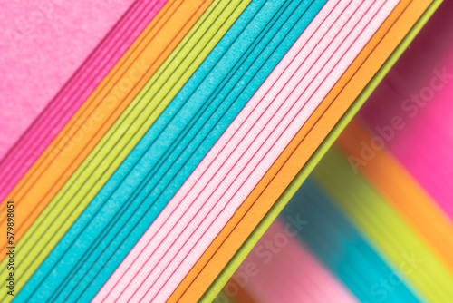 A stack of bright paper for artistic projects.