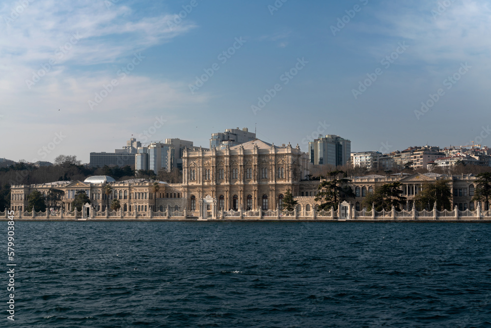 View of Dolmabahce Palace in Besiktas district on the European shore of the Bosphorus Strait on a sunny day, Istanbul, Turkey