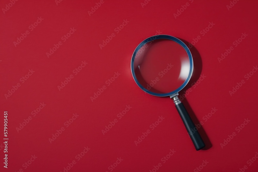 Isolated red magnifying glass on a red background Isolated red magnifying glass on a red background