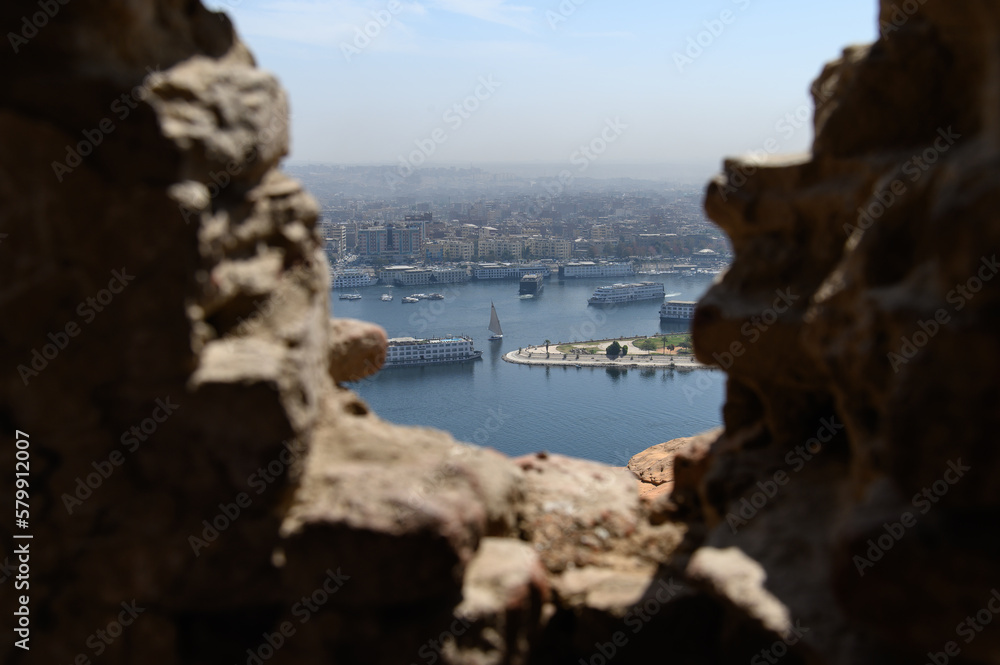 A view of Nile felucca at Aswan city from ancient El Hawa dome (Qubbet Elhawa) a window