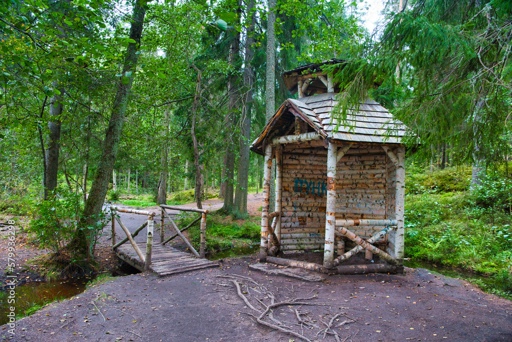 Birch booth shack and small bridge in the forest, Park Mon Repos, Vyborg, Russia Birch booth shack and small bridge in the forest, Park Mon Repos, Vyborg, Russia