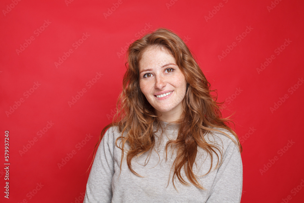 Smiling brunette woman on red background Smiling brunette woman on red background
