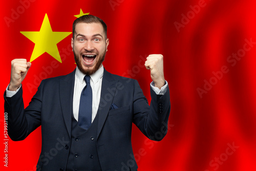 Chinese happy businessman on the background of flag of China Business, education, degree and citizenship concept photo