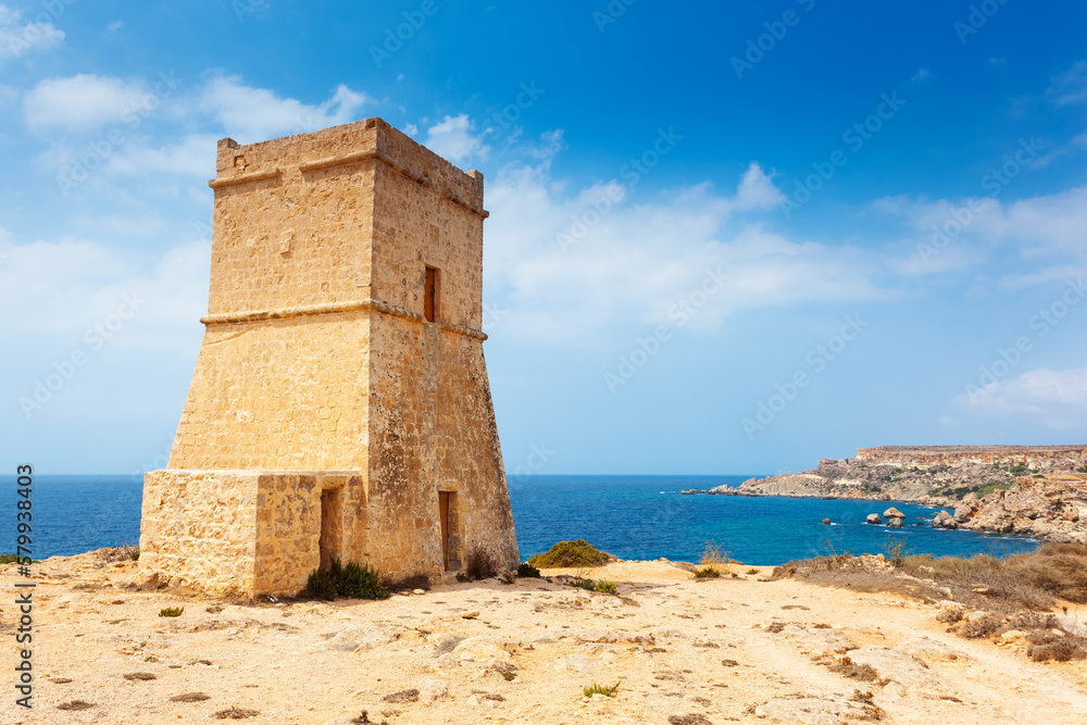 Ghajn Tuffieha watchtower at Golden Bay on a sunny day. North-west coast of Malta island, Europe.