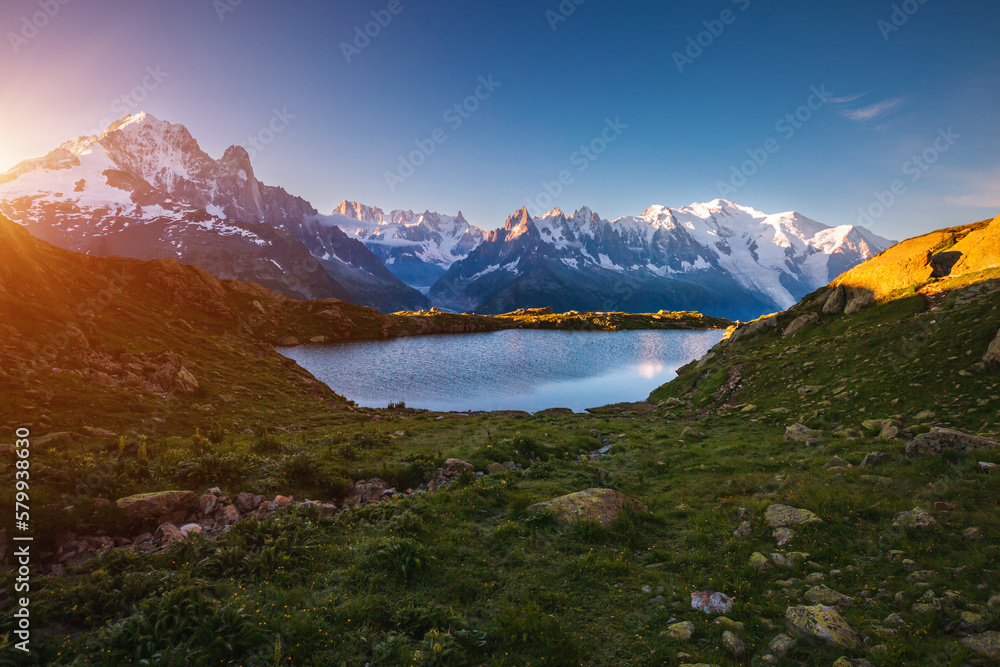 Perfect morning scene of high alpine lake Lac Blanc and Mont Blanc glacier. Graian Alps, France, Europe.
