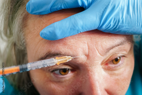 Aged lady having botox injecting procedure. Cosmetic treatment