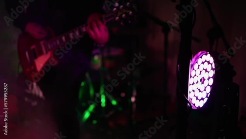 Man is playing guitar on stage.close up,Animation multicolor lights