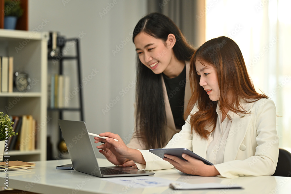 Smiling business coworkers are collaborating, brainstorming over new marketing during corporate meeting Smiling business coworkers are collaborating, brainstorming over new marketing during corporate meeting