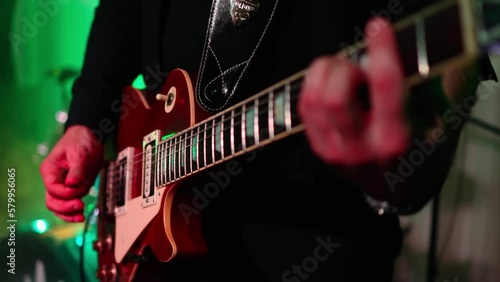 Man is playing guitar on stage.close up,Animation multicolor lights