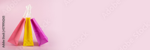 online shopping delivery banner,shopping bags on pink background, copy space, gift bag