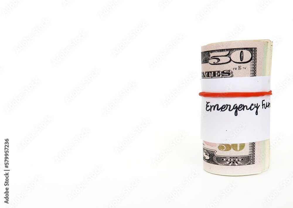 Money management saving budget plan, small cash wrapped separately with rubber band for emergency fund saving- on white copy space background Money management saving budget plan, small cash wrapped separately with rubber band for emergency fund saving- on white copy space background