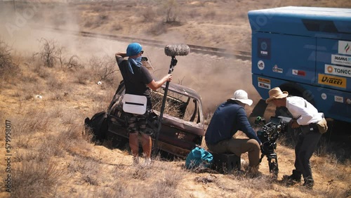Film crew in the desert. shooting undermining a truck speeding through the desert. Pyrotechnics. movie production photo