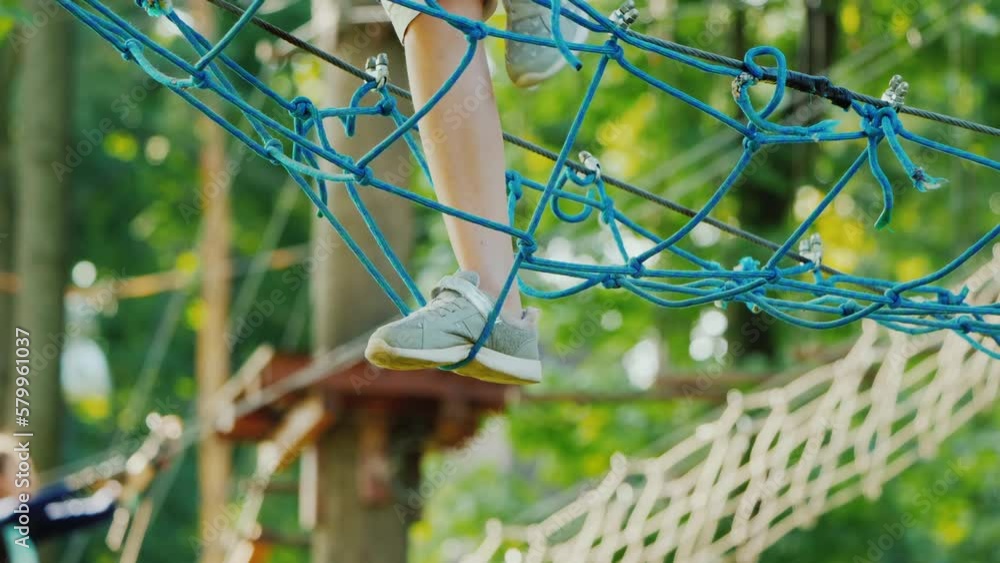 Feet strode on a rickety grid stretched high above the ground Feet strode on a rickety grid stretched high above the ground