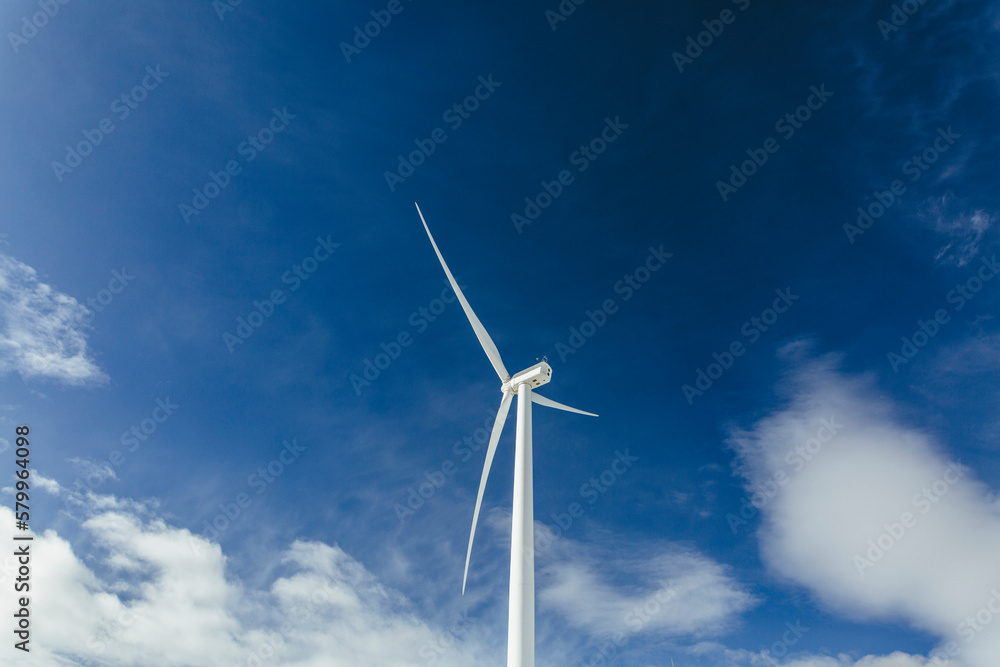 Low angle view of Windmill against blue sky Low angle view of Windmill against blue sky